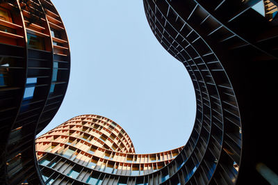 Low angle view of modern buildings against clear sky