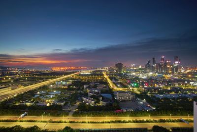 High angle view of city lit up at night