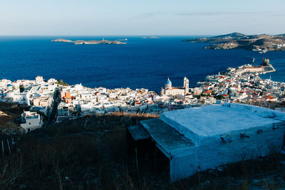 High angle view of townscape by sea against sky