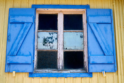 Low angle view of blue window on old building