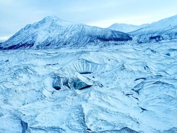 Frozen landscape against sky