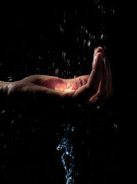 Midsection of person touching water in bathroom