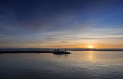 Scenic view of sea against sky at sunset