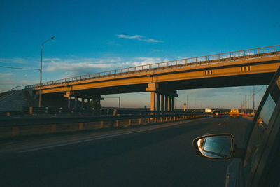 Bridge over road against sky in city