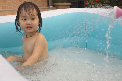 Portrait of shirtless boy in swimming pool