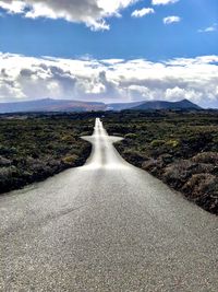 Road amidst landscape against sky