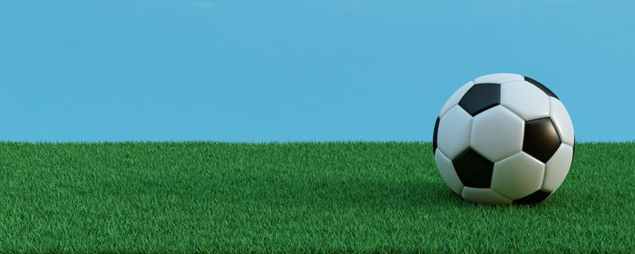 Soccer ball on field against clear sky
