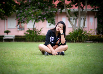 Young woman sitting on field