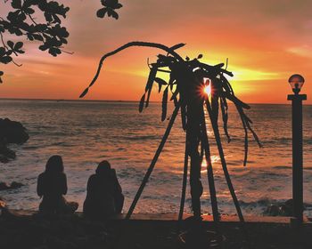 Silhouette people on beach during sunset