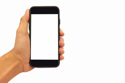 Close-up of hand holding mobile phone against white background