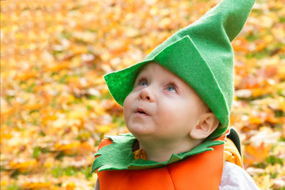 Close-up of boy with autumn leaves