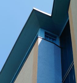 Low angle view of building against clear blue sky