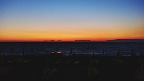 Scenic view of sea against clear sky during sunset