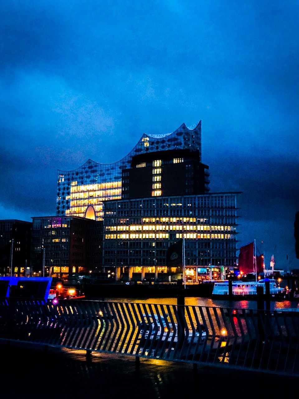 ILLUMINATED MODERN BUILDINGS AGAINST BLUE SKY