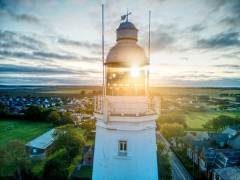 High angle view of lighthouse amidst buildings in city