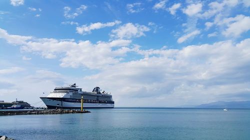 Ship sailing in sea against sky