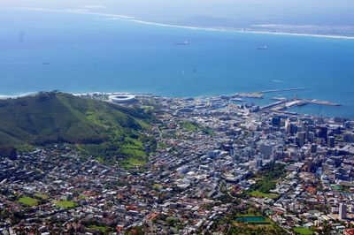 High angle view of townscape by sea against sky