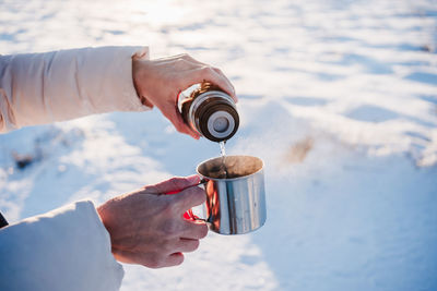 High angle view of hand pouring water