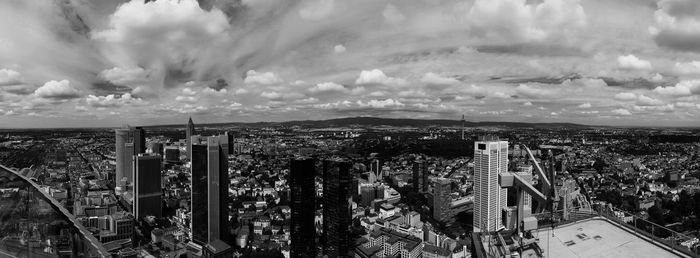 Panoramic view of cityscape against cloudy sky