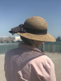 Rear view of man looking at sea against sky