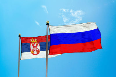 Flags against blue sky