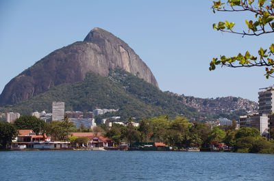 View of buildings by sea against sky