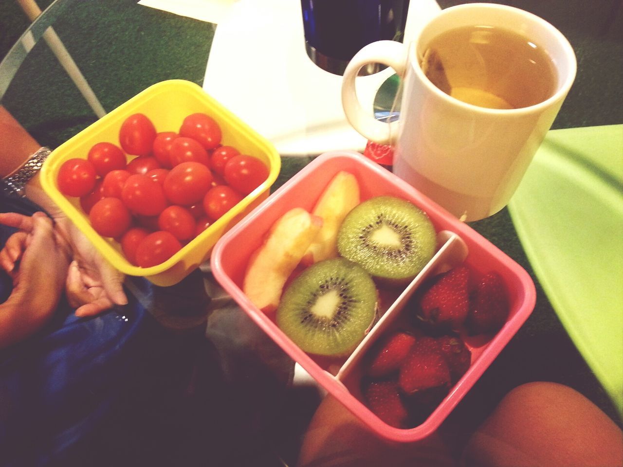 food and drink, food, freshness, indoors, person, drink, holding, healthy eating, refreshment, fruit, part of, lifestyles, table, coffee cup, unrecognizable person, cropped, high angle view