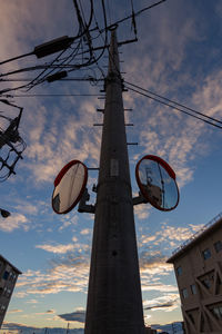 Low angle view of communications tower against sky during sunset