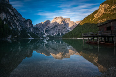 Scenic view of lake by mountains against sky