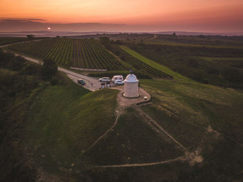 High angle view of agricultural field against sky during sunset