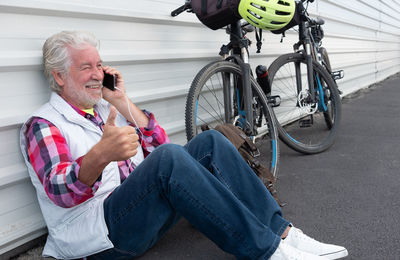 Man using mobile phone while sitting on bicycle