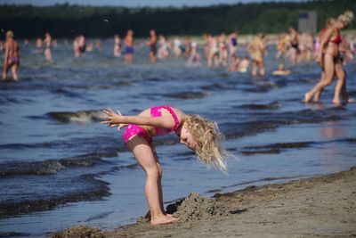 Woman playing in water at beach