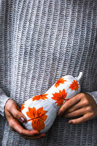 Close-up of hand holding orange flower