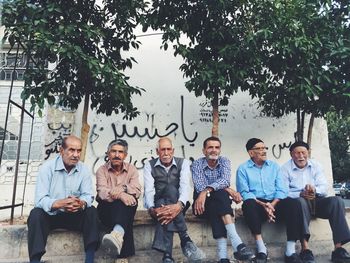 Portrait of people sitting outdoors