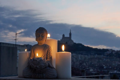 Buddha against sky at sunset