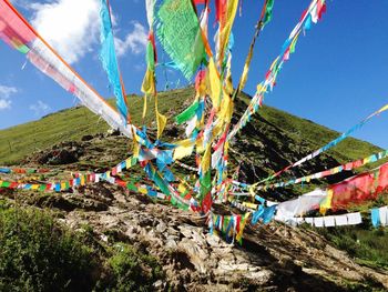 Low angle view of colorful balloons against blue sky