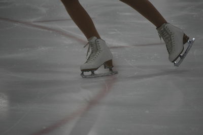 Low section of person ice skating on snow