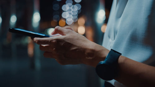 Midsection of woman using mobile phone