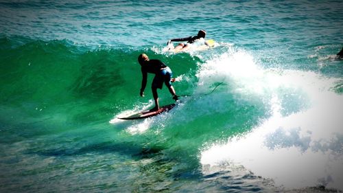 People surfing in sea