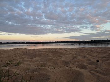 Scenic view of beach against sky during sunset