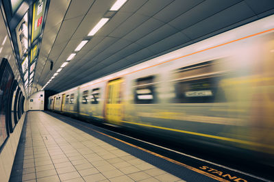 Blurred motion of train at railroad station