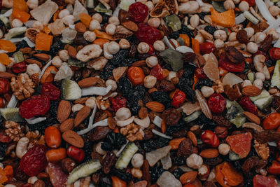 Mixed nuts. natural background of unpeeled peanuts, dried fruits, raisins, hazelnuts, coconut