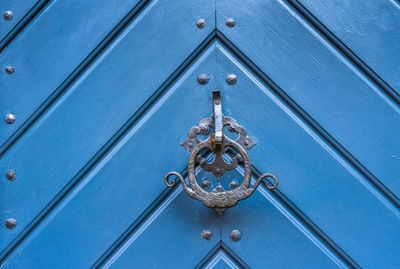 Full frame of blue wooden door with knocker