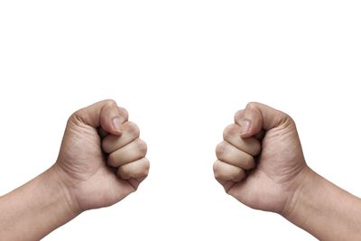 Close-up of hands against white background