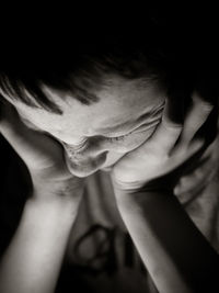 Close-up of frustrated boy in darkroom