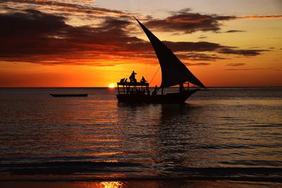 Silhouette sailboat on sea against sky during sunset