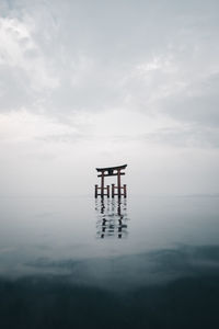 Lifeguard hut on sea against sky