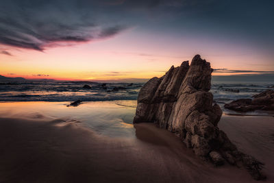 Scenic view of beach against sky during sunset