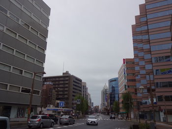 City street and buildings against sky