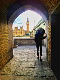 Full length rear view of man walking in city